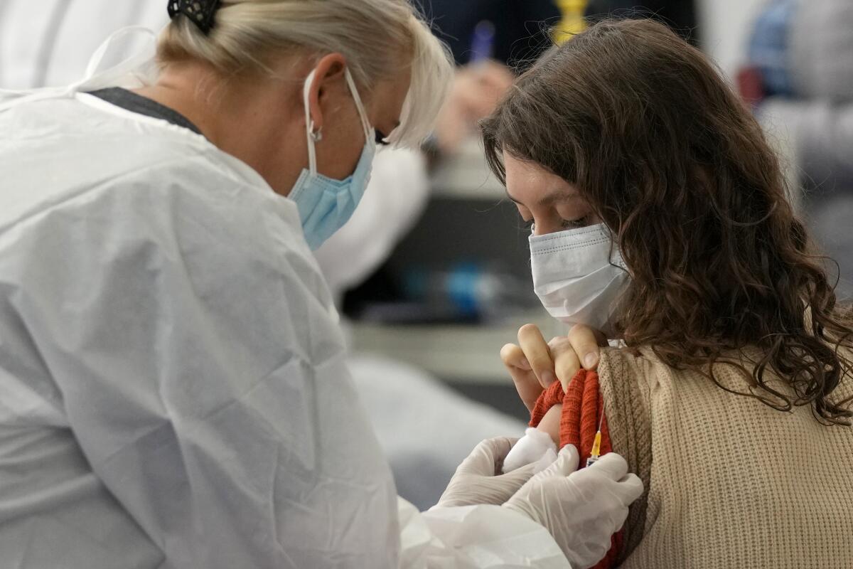 A woman from Russia is administered a dose of the Johnson COVID-19 vaccine in Zagreb, Croatia, Tuesday, Nov. 9, 2021. Despite its infection surge, Croatia is becoming a new favored destination for Russians seeking vaccination with Western jabs, which they need to travel around Europe and the U.S. (AP Photo/Darko Bandic)