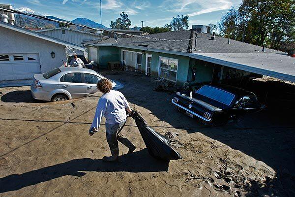 The Mortan family was allowed to enter their home Friday to retrieve some belongings after the week's rains caused a concrete channel to burst, sending floodwaters and mud rushing down on the San Bernardino County community of Highland. See full story
