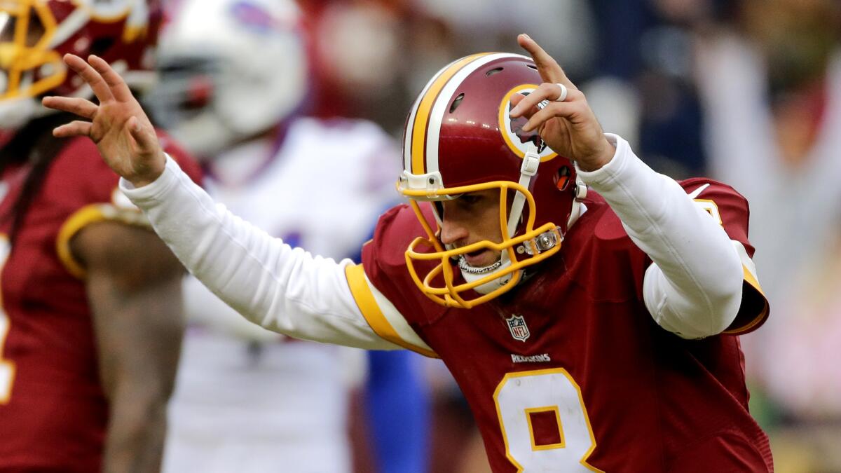 Redskins quarterback Kirk Cousins (8) celebrates after connecting with wide receiver Pierre Garcon for a touchdown Sunday.