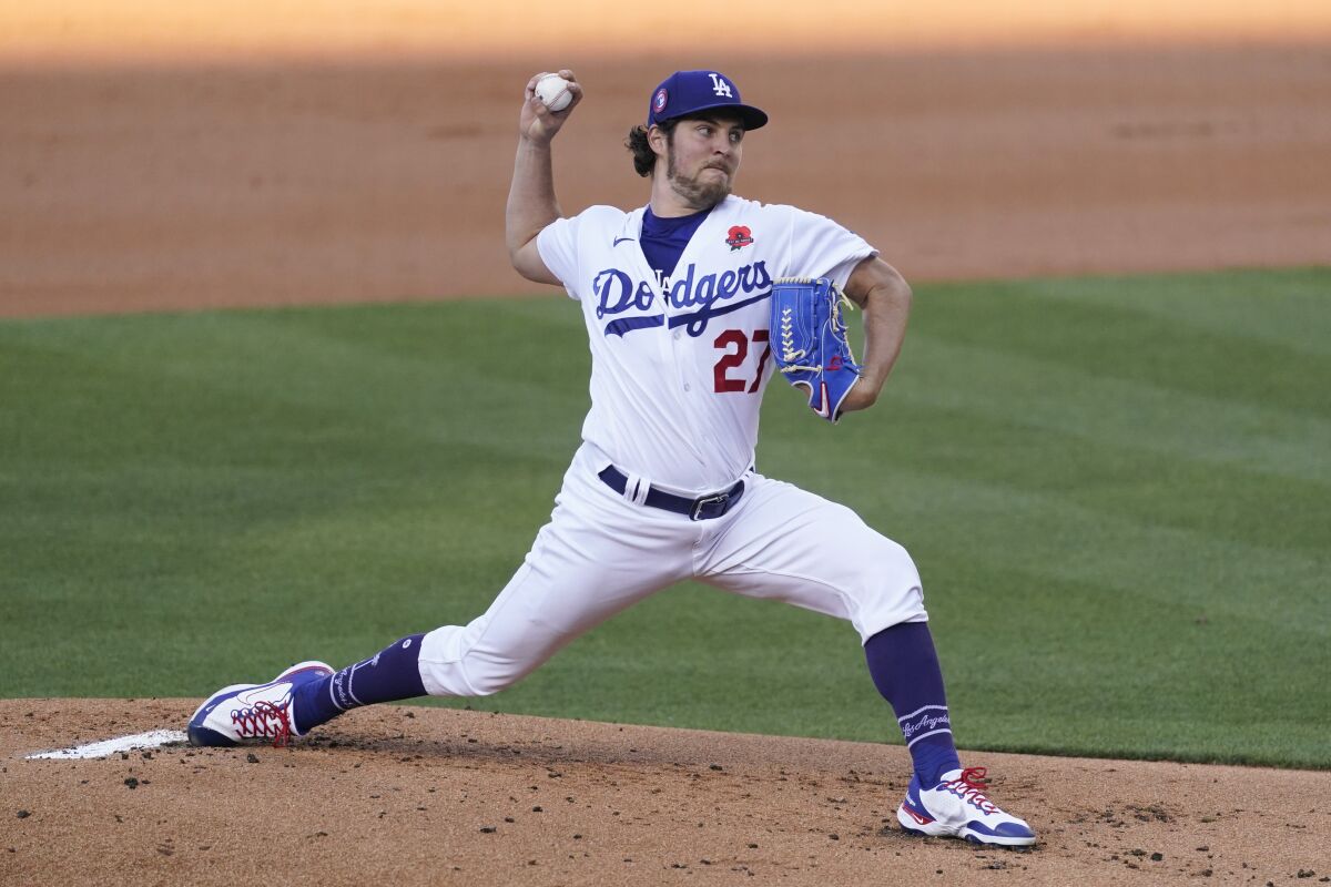Dodgers starting pitcher Trevor Bauer (27) throws during the first inning.