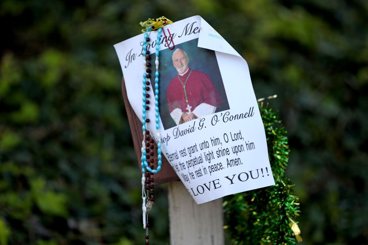 Rosary beads hang from a picture of Bishop David O'Connell near his home in Hacienda Heights.