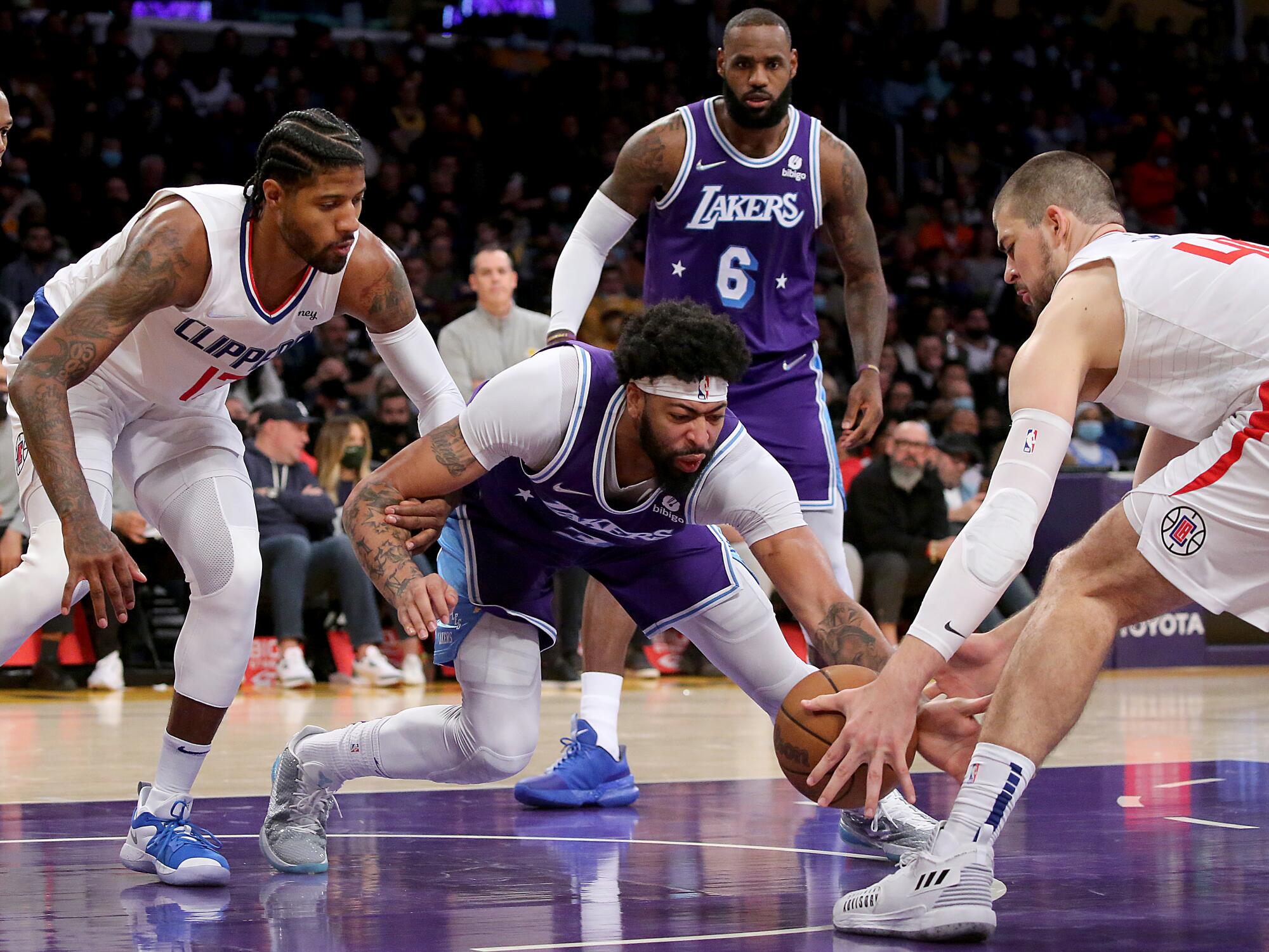 Lakers power forward Anthony Davis fights for loose ball.