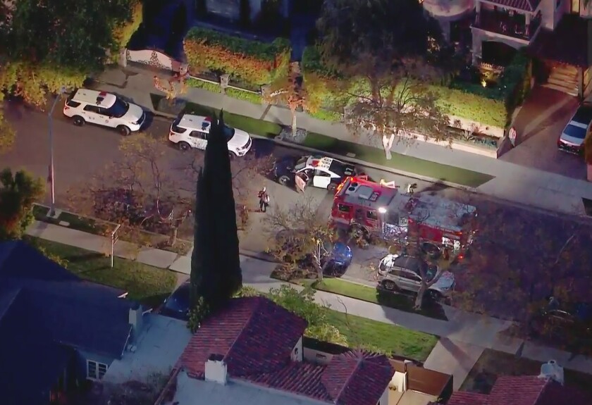 An aerial view of a police cars in a neighborhood. 