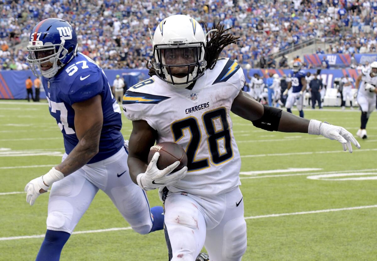 Chargers running back Melvin Gordon gets past Giants linebacker Keenan Robinson for a touchdown during a game last season.