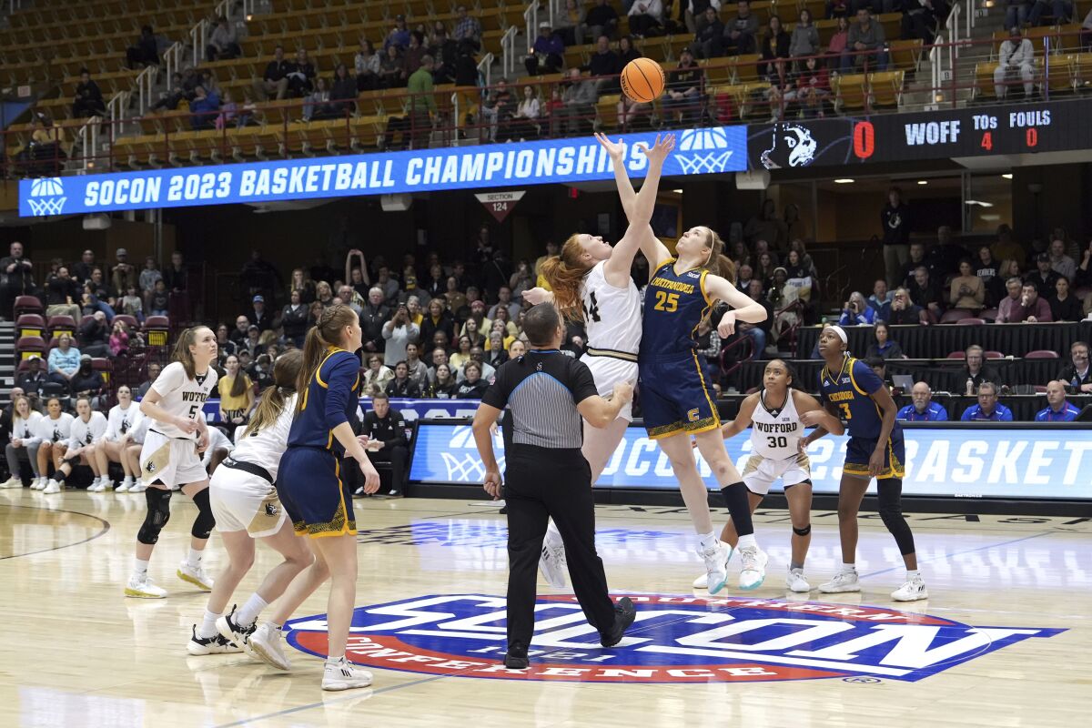 Wofford forward Lilly Hatton (14) and Chattanooga forward Abbey Cornelius (25) tip off for the start of the first half of an NCAA women's college basketball championship game for the Southern Conference tournament, Sunday, March 5, 2023, in Asheville, N.C. (AP Photo/Kathy Kmonicek)