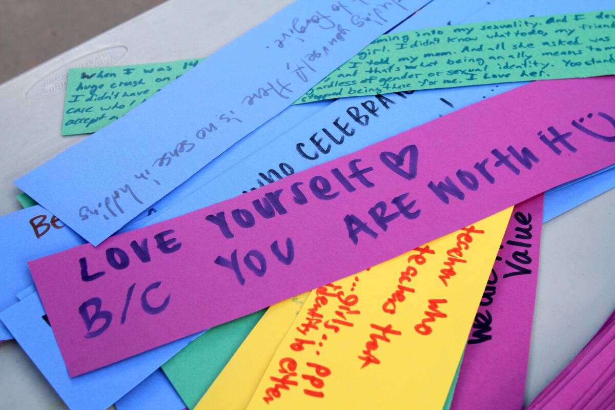 Crescenta Valley High School Gay Straight Alliance allies wrote messages on paper strips during lunch hour at the La Crescenta school on Tuesday, November 3, 2015. The strips of paper will be rolled into a circle like links and made into a chain.