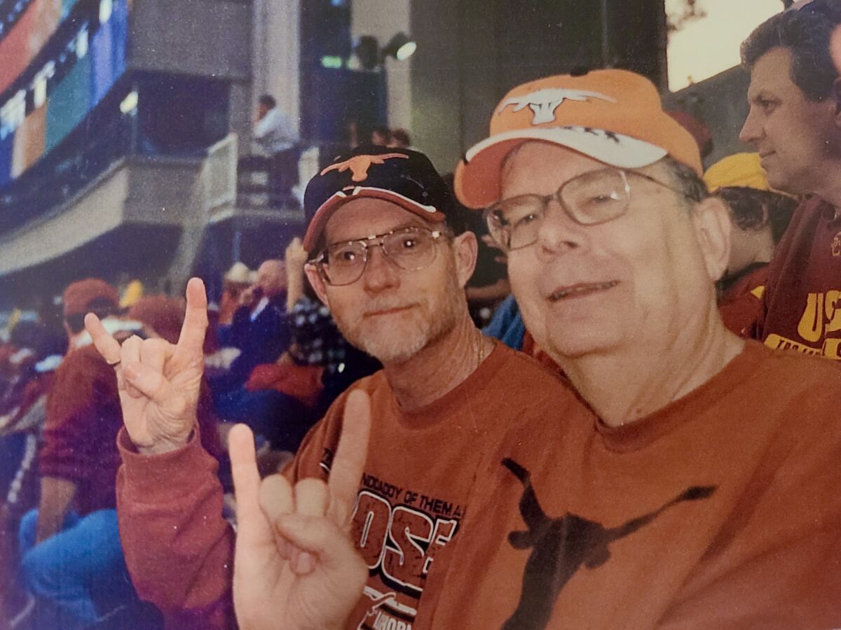 Don Hunt and his cousin Phil Worley make the "Hook 'em Horns" gesture at the 2006 Rose Bowl game.