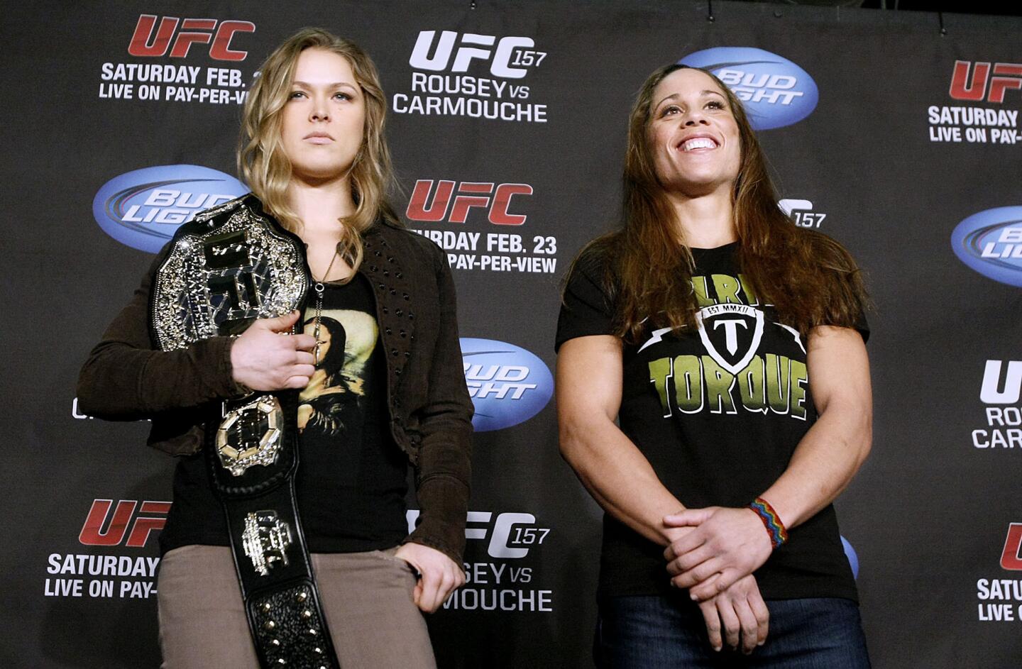 UFC's first-ever Women's Bantamweight Champion Ronda Rousey, left, strikes a pose next to contender Liz Carmouche, right, during press conference at the Honda Center in Anaheim on Thursday, February 21, 2013. Rousey, who trains at the Glendale Fighting Club in Glendale, will defend her title against former Marine Carmouche on Saturday, February 23, 2013.