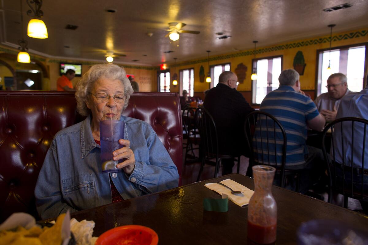 Winnie Abbott sips water at El Acapulco in Cave City, Ark. Mexican food is a favorite of Abbott's.