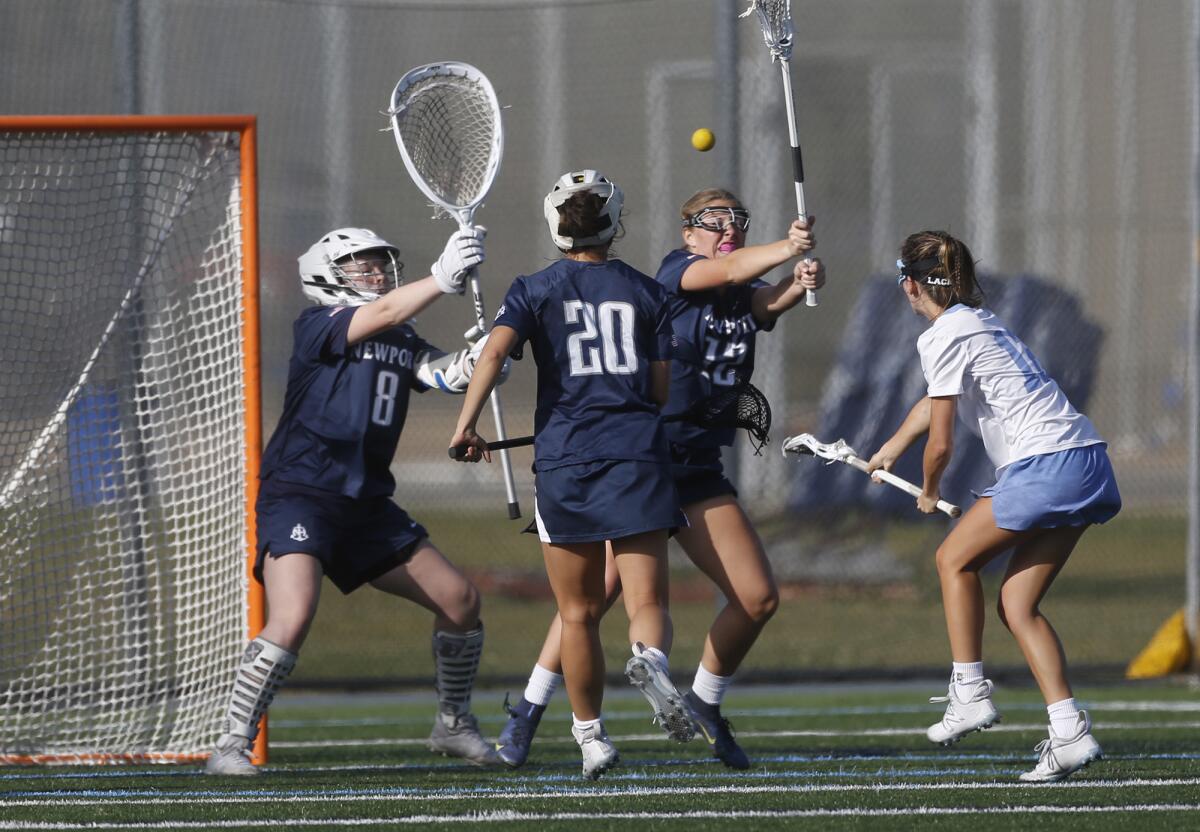 Corona Del Mar's Maile Lyle (12) takes a shot in traffic against Newport Harbor on Thursday.