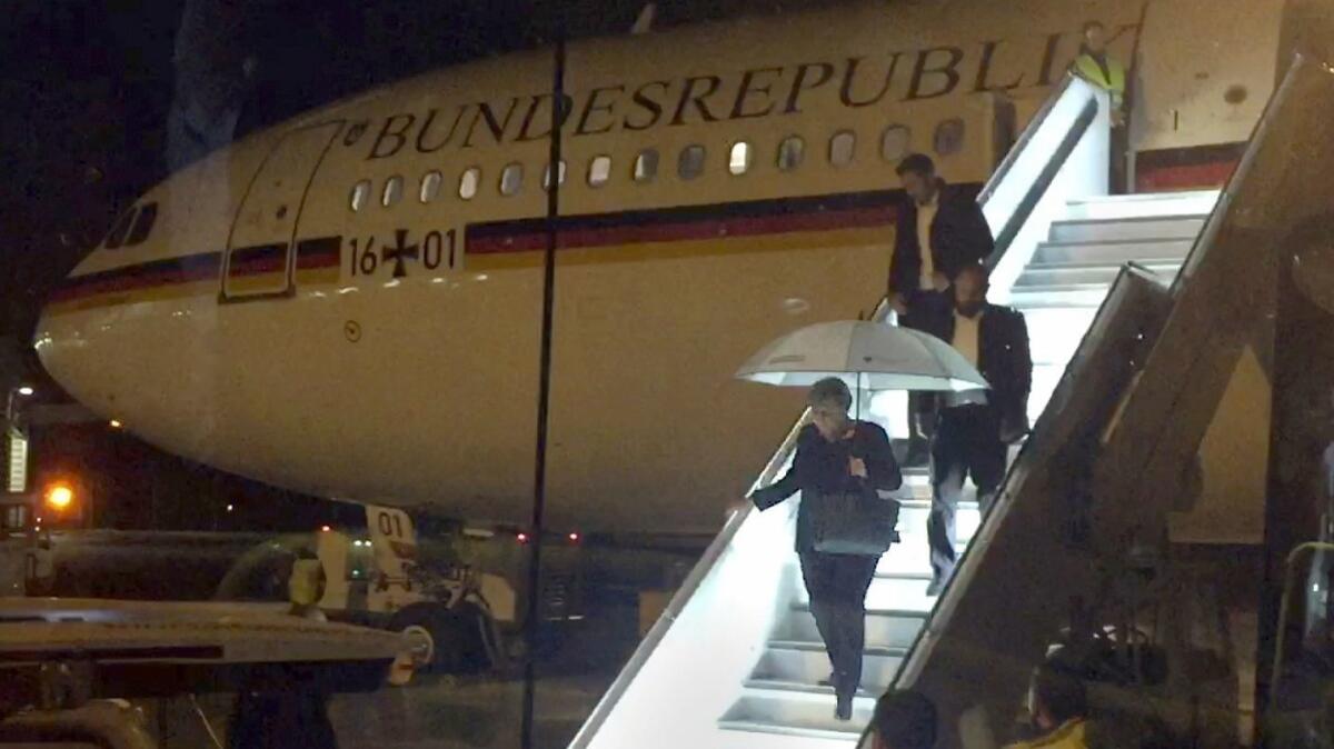 German Chancellor Angela Merkel leaves the chancellor's Airbus in Cologne last year after making an emergency landing.
