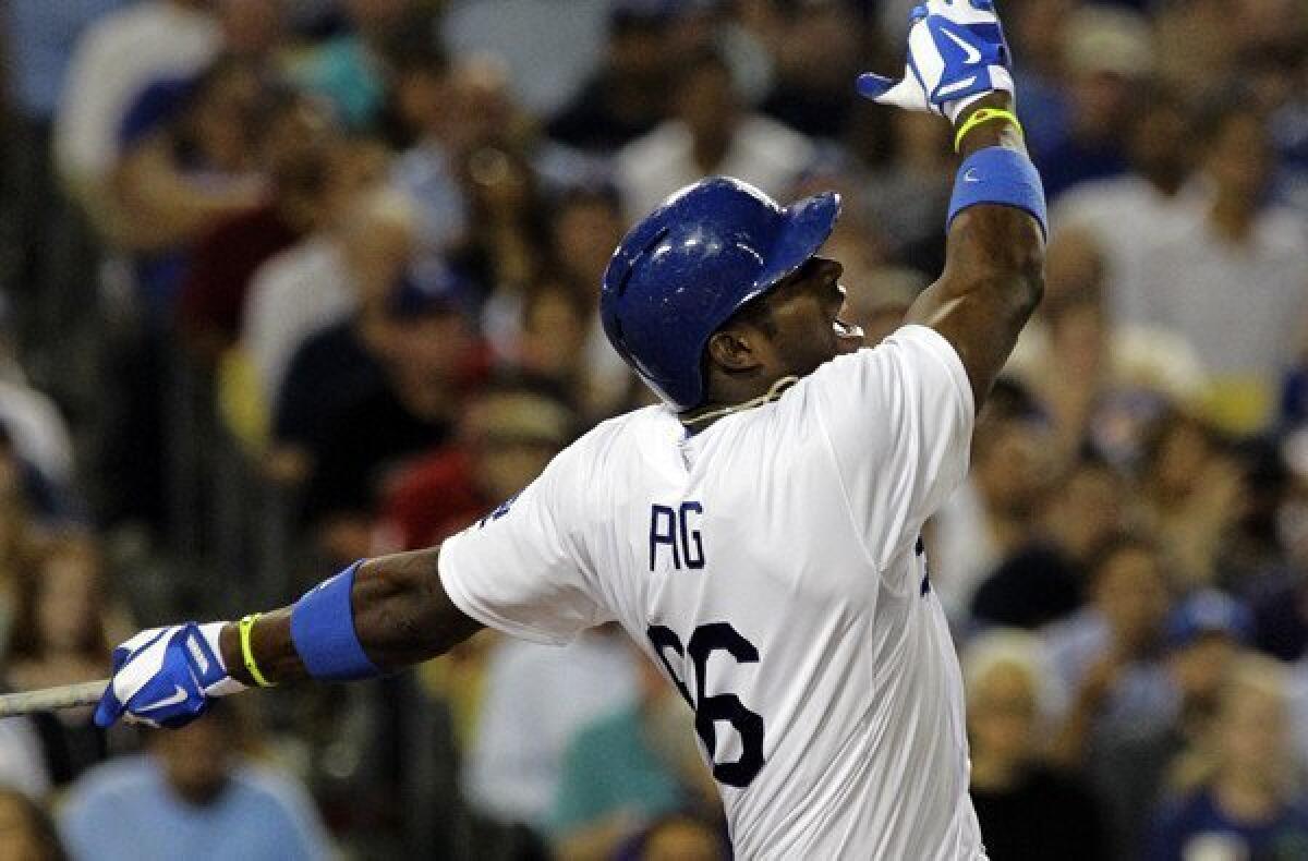 Dodgers right fielder Yasiel Puig follows through on a big swing against the Rockies in the third inning at Dodger Stadium.