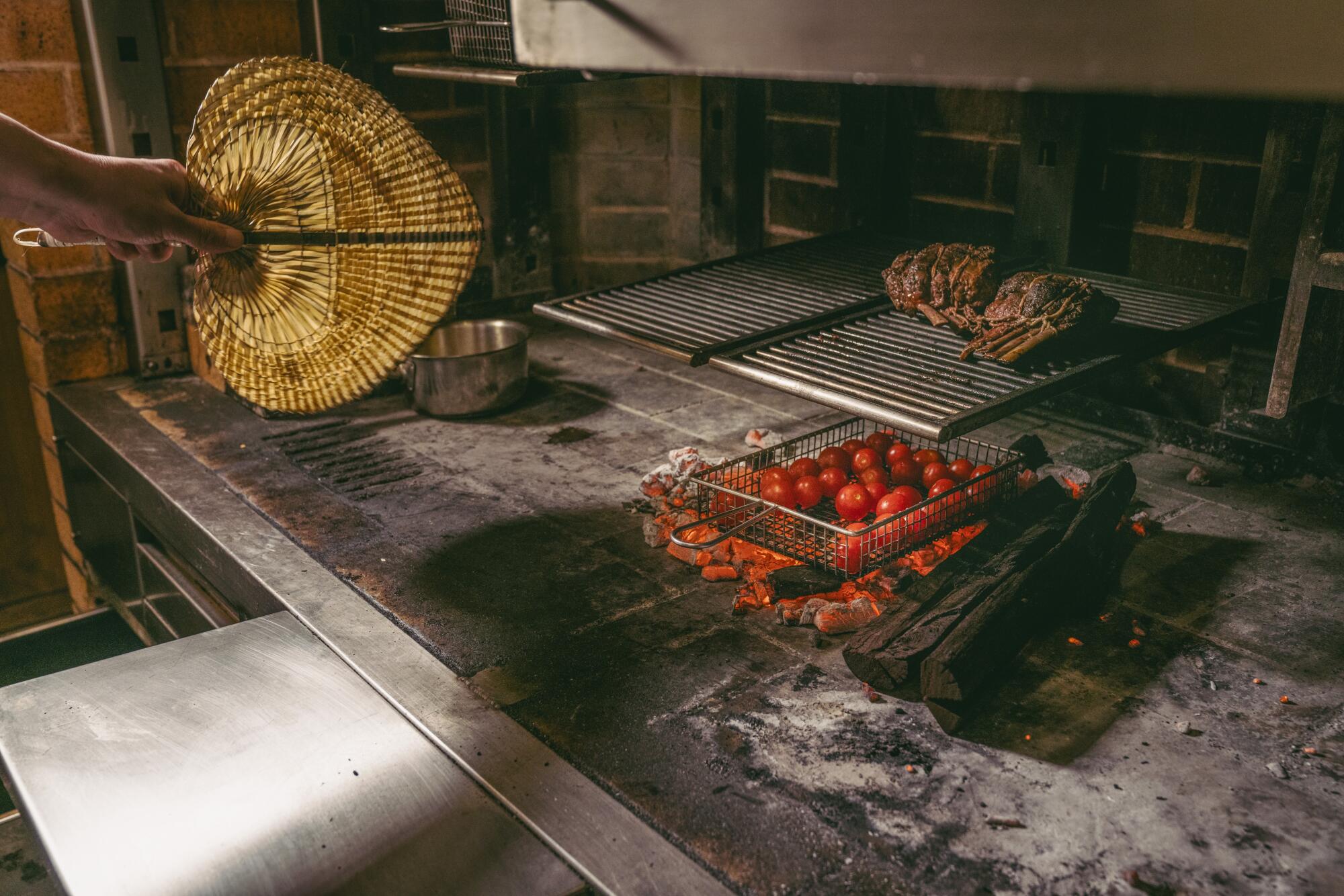 Cherry tomatoes cook in a huge stove