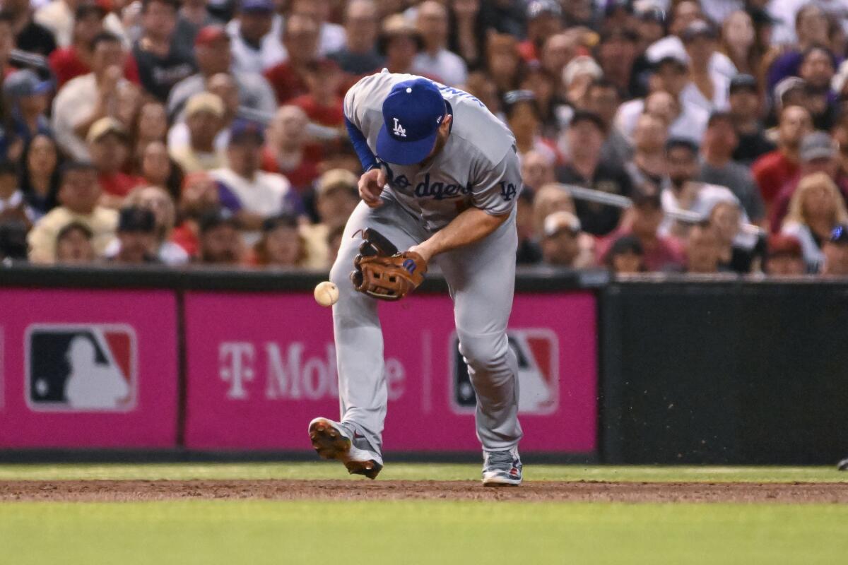Dodgers third baseman Max Muncy bobbles a ball during Game 3 against the Arizona Diamondbacks on Oct. 11.