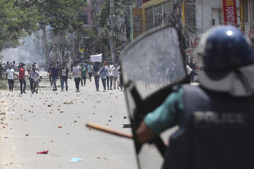 Students clash with riot police during a protest against a quota system for government jobs, in Dhaka, Bangladesh, Thursday, July 18, 2024. (AP Photo/Rajib Dhar)