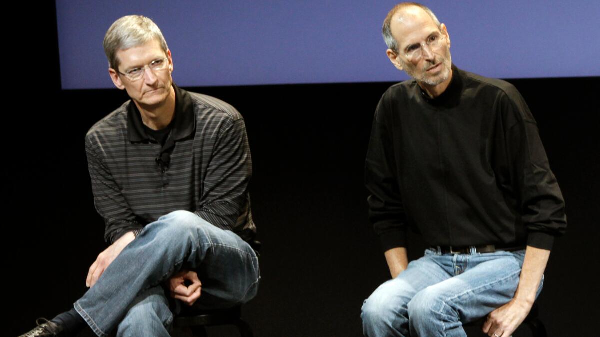 This July 16, 2010, file photo shows Apple's Tim Cook, left, and Steve Jobs, who died in 2011 after receiving a liver transplant that was credited with extending his life.