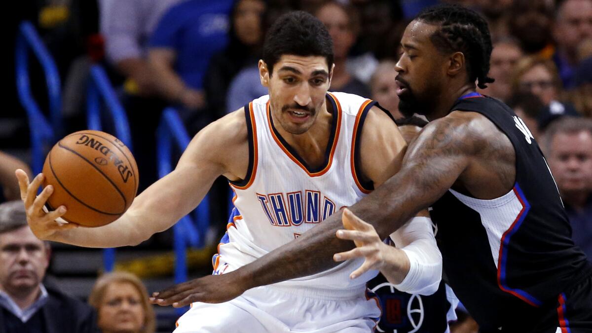 Clippers center DeAndre Jordan tries to strip the ball from Thunder center Enes Kanter during their game Saturday night.