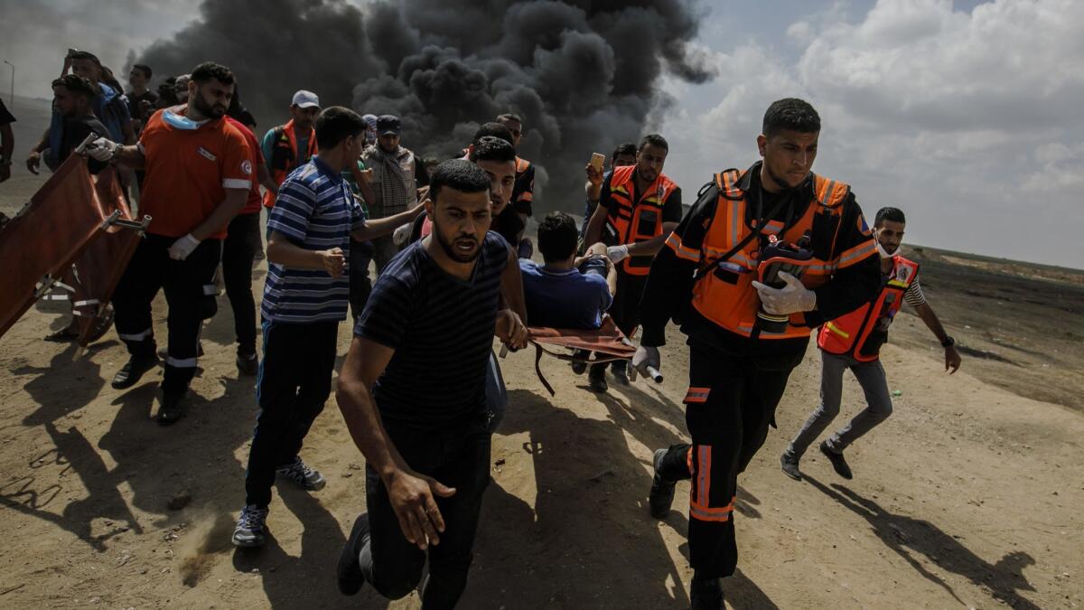 Medical units carry an injured man during clashes with Israeli forces near the border between the Gaza Strip and Israel on May 14.