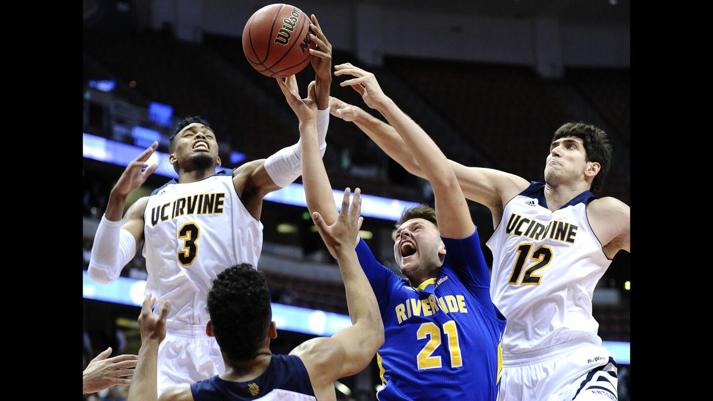 UC Irvine forward Will Davis III (3) grabs a rebound from UC Riverside forward Alex Larrson (21) and Anteaters center Ioannis Dimakopoulos in a Big West Conference tournament quarterfinal game Thursday at Honda Center in Anaheim.