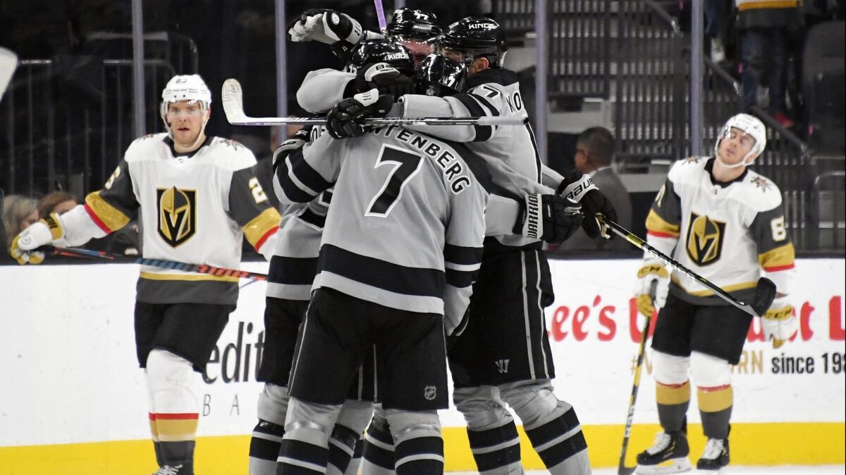 The Kings celebrate on the ice after Tyler Toffoli scored an overtime goal against the Vegas Golden Knights to win their game 4-3 on Sunday.