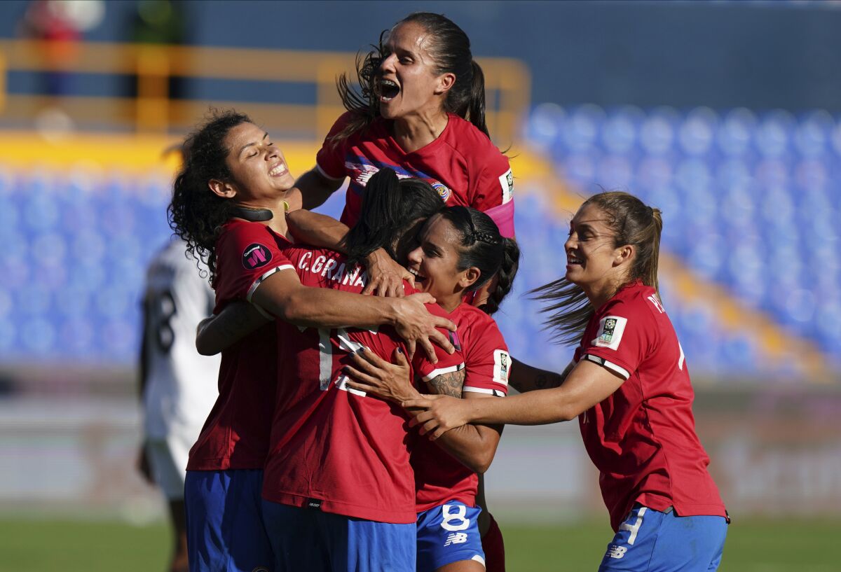 Costa Rica's Cristin Granados is congratulated by her teammates after scoring her side's third goal against Trinidad and Tobago during a CONCACAF Women's Championship soccer match in Monterrey, Mexico, Friday, July 8, 2022. (AP Photo/Fernando Llano)