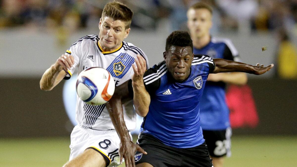 Galaxy midfielder Steven Gerrard, left, Earthquakes midfielder Fatai Alashe vie for possession of the ball during an MLS game on July 17.