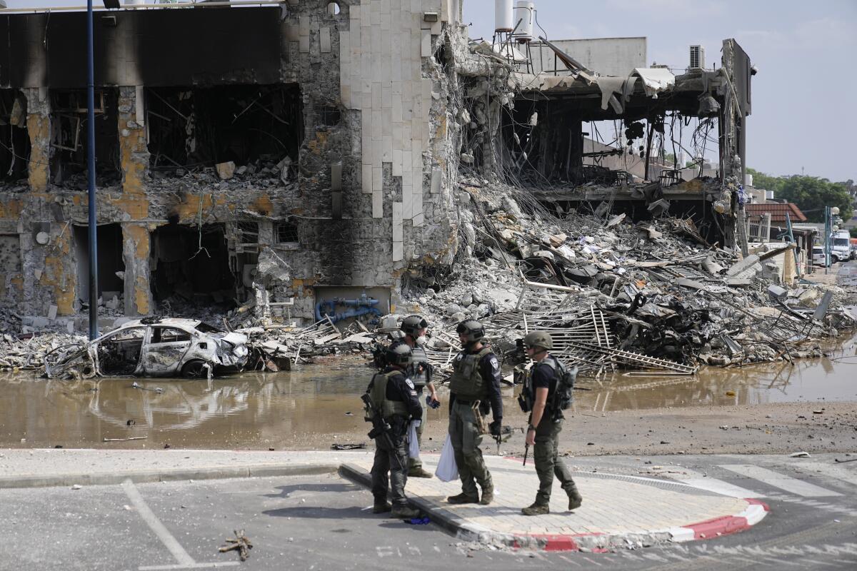 Israeli police outside a destroyed building in Sderot.