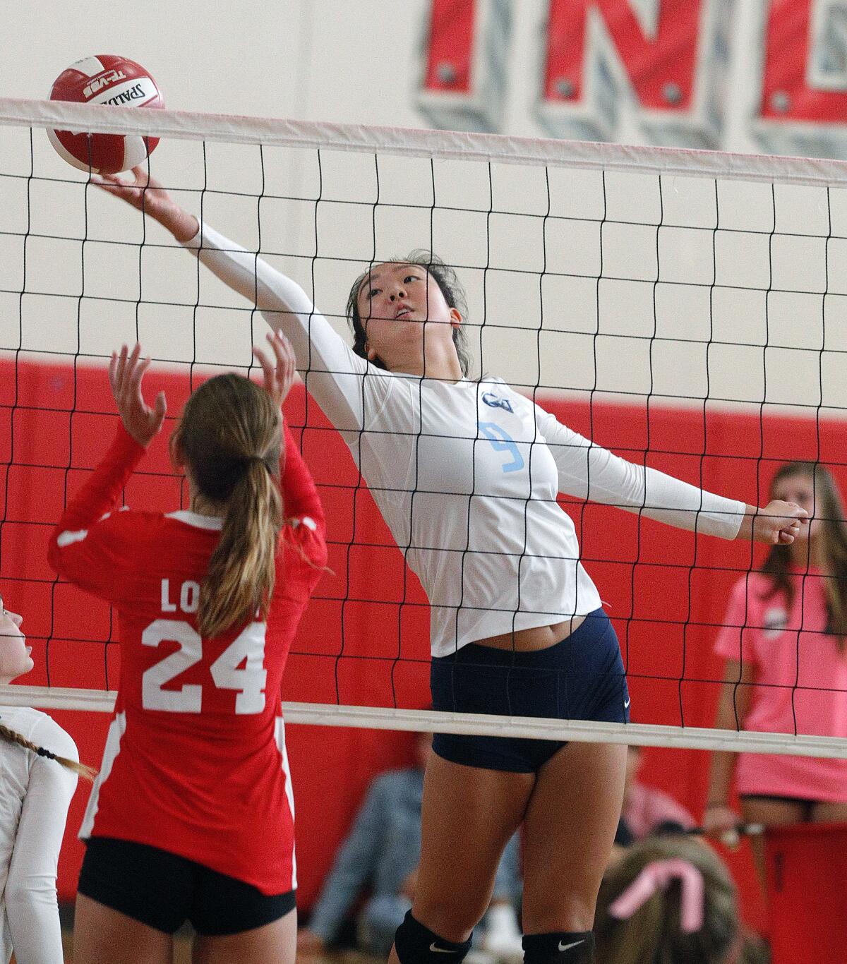 Crescenta Valley's Ellie Song reaches out to hit the ball against Burroughs in a Pacific League girls' volleyball match at Burroughs High School on Tuesday, October 8, 2019.