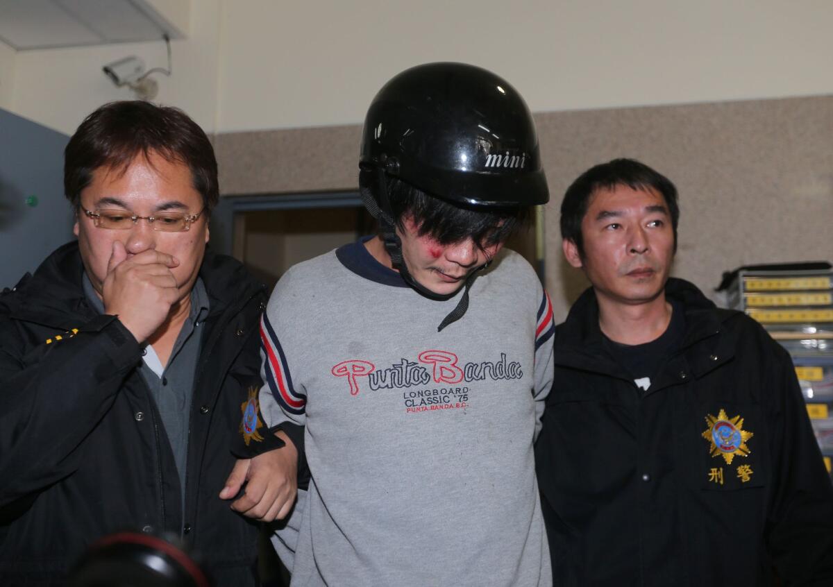 Police escort a man who allegedly attacked and killed a Taiwanese toddler in Taipei, sending shock waves through the island.