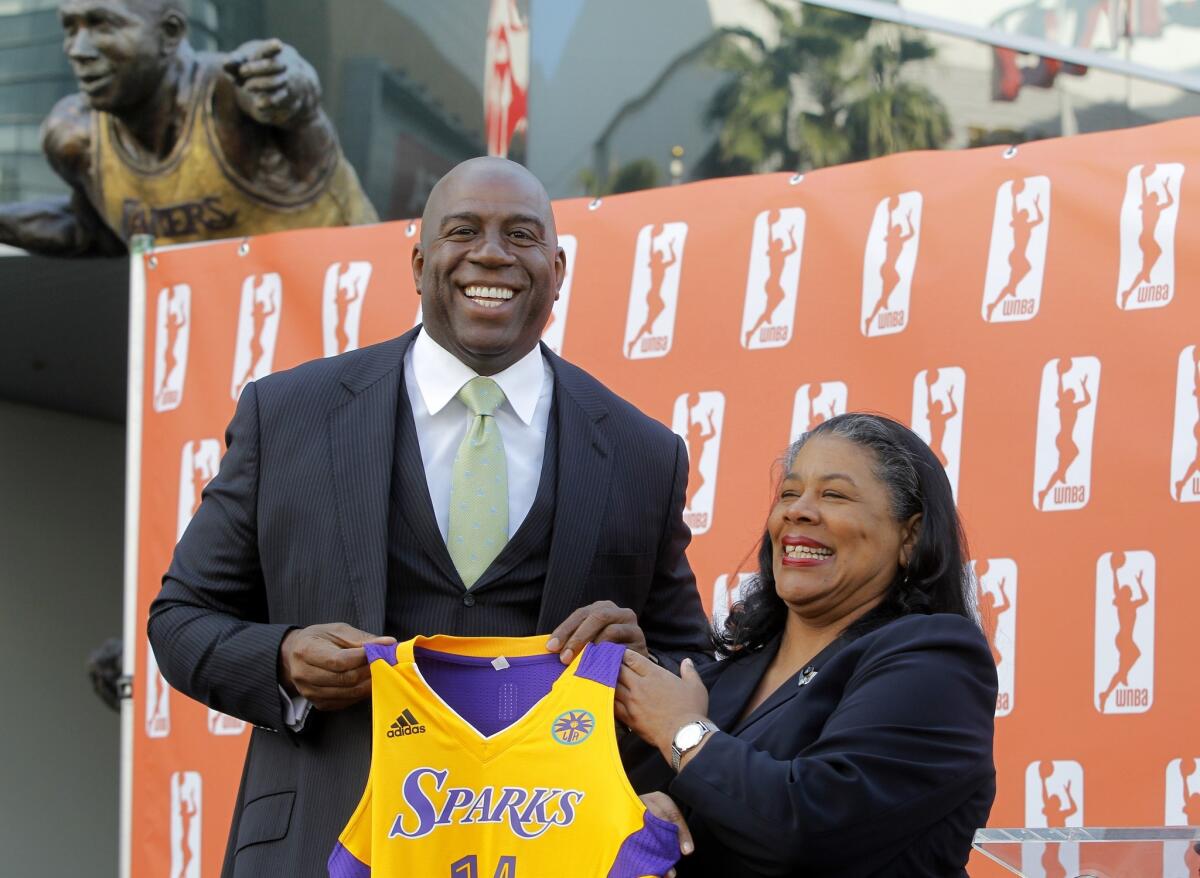 Magic Johnson, left, is part of an investment group that bought the Sparks in February after the team's former owners suddenly announced they would no longer be involved with the team in January.