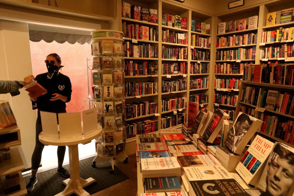 Bookseller Mia Wigmore, left, helps customer Olivia Janisch at the Diesel, A Bookstore in Brentwood.