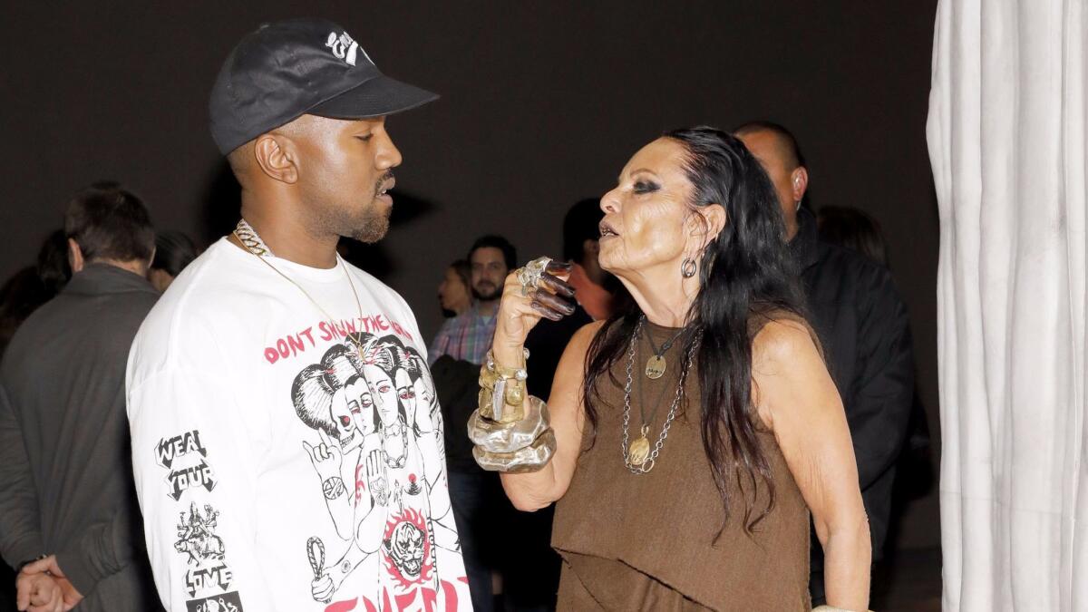 Kanye West talks with Michèle Lamy at the opening party for the Museum of Contemporary Art exhibition "Rick Owens: Furniture."
