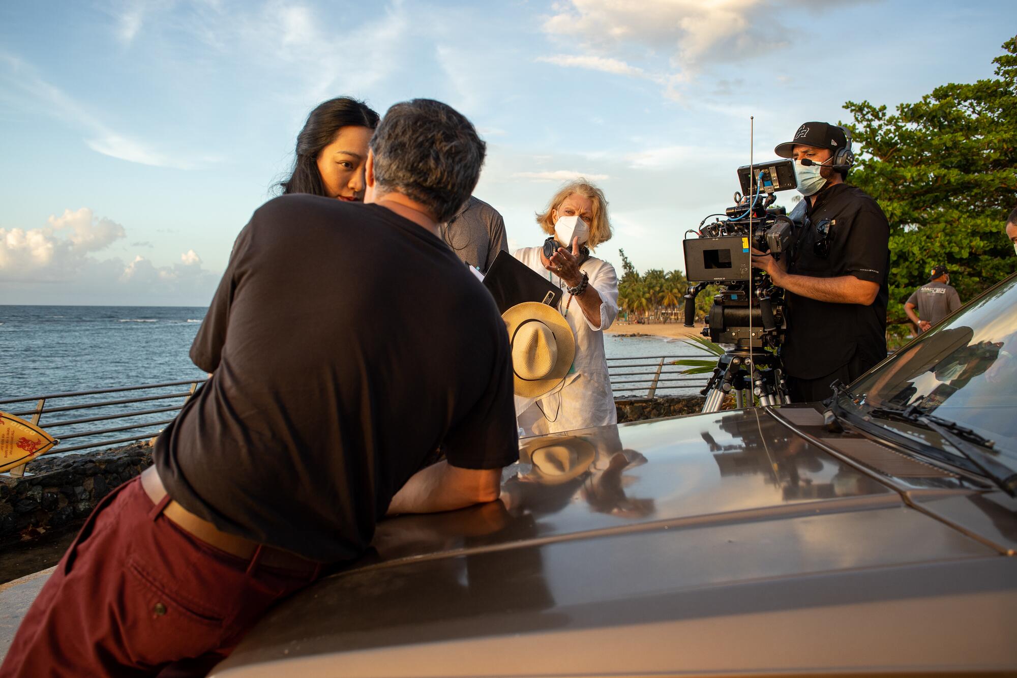 Filming a scene of "Simone," with crew members wearing masks.  