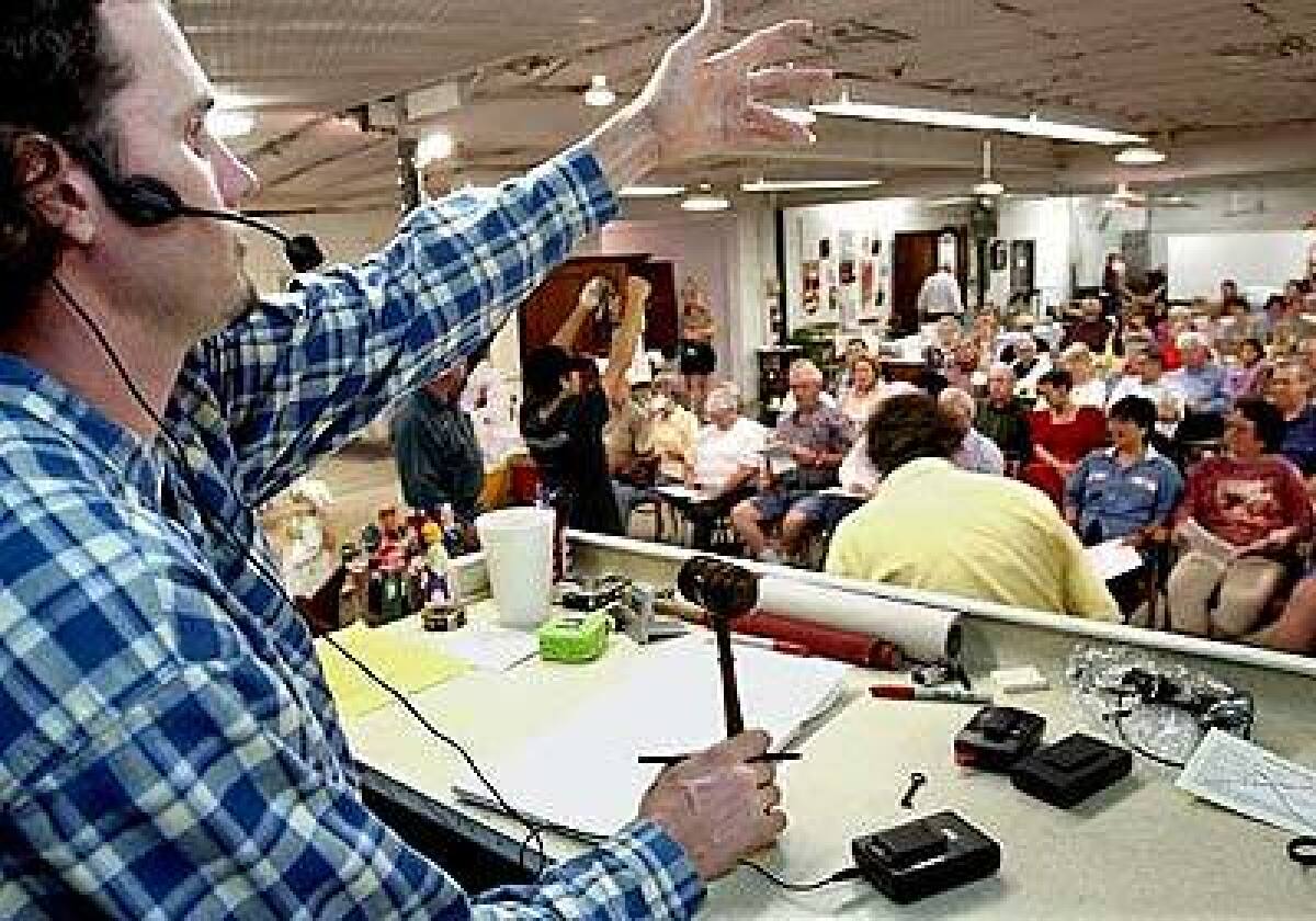 Charles Riley looks for bids at an auction in Blanco. Sales can have a theme or be a total hodgepodge.