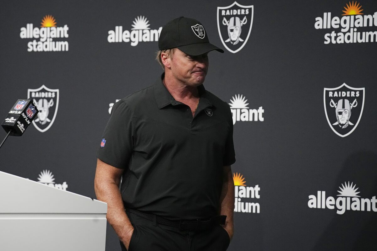 FILE - Las Vegas Raiders head coach Jon Gruden leaves after speaking during a news conference after an NFL football game against the Chicago Bears in Las Vegas, in this Sunday, Oct. 10, 2021, file photo. Jon Gruden is out as coach of the Las Vegas Raiders after emails he sent before being hired in 2018 contained racist, homophobic and misogynistic comments. Gruden released a statement Monday night, Oct. 11, 2021, that he is stepping down after The New York Times reported that Gruden frequently used misogynistic and homophobic language directed at Commissioner Roger Goodell and others in the NFL. (AP Photo/Rick Scuteri, File)
