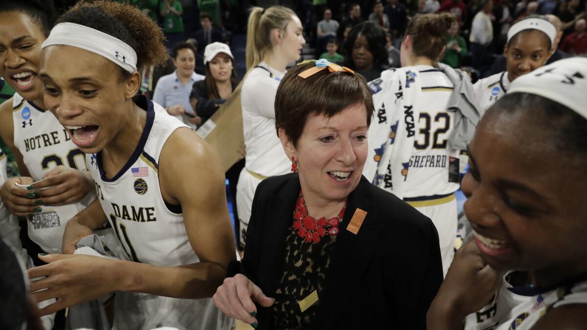 Notre Dame coach Muffet McGraw celebrates with her team after defeating Stanford 84-68 in a regional championship game on April 1, 2019.