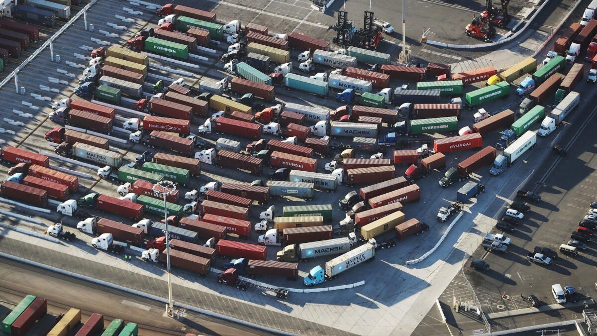 Trucks with shipping containers at the Port of Los Angeles on Sept. 18.