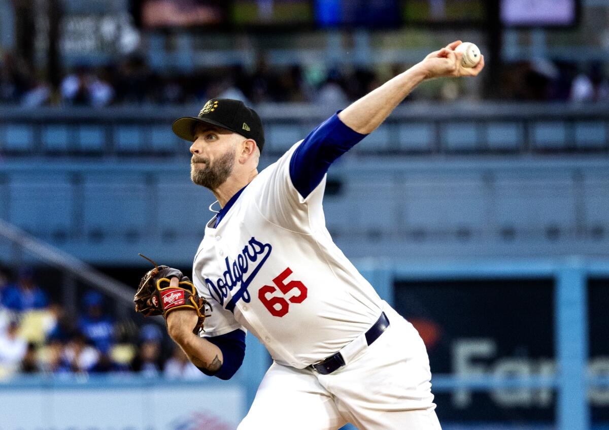Dodgers left-hander James Paxton pitching in a home uniform, No. 65