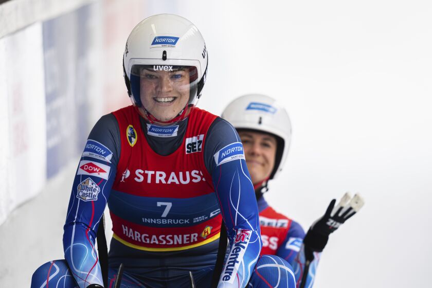 Summer Britcher and Emily Sweeney of the United States react during the women's double sprint race at the Luge World Cup in Igls near Innsbruck, Austria, Sunday, Dec. 4, 2022. (AP Photo/Florian Schroetter)