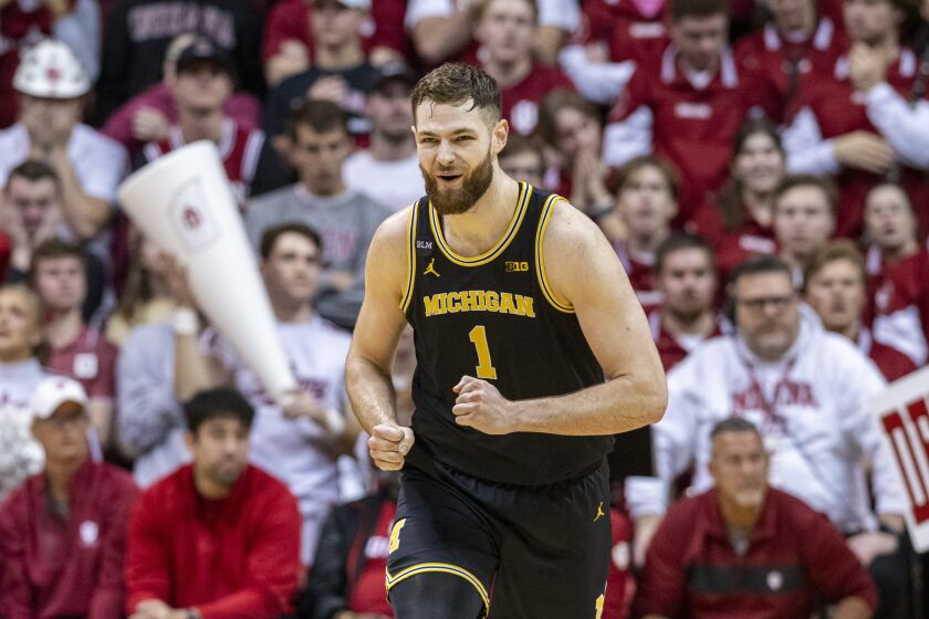 Michigan center Hunter Dickinson (1) reacts after scoring during the second half of an NCAA college basketball game against Indiana, Sunday, March 5, 2023, in Bloomington, Ind. (AP Photo/Doug McSchooler)