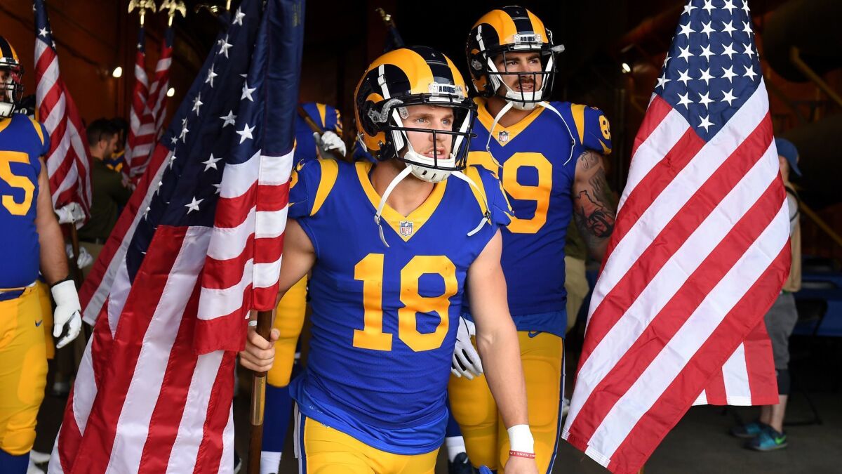 Rams wide receiver Cooper Kupp carries the American flag before a game against the Seahawks at the Coliseum in November.