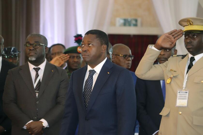 FILE - Togo's President, Faure Gnassingbé, centre, looks on, prior to the start of the ECOWAS meeting, in Abuja, Nigeria, Saturday, Feb. 24, 2024. Togolese voters headed to the polls on Monday, April 29, 2024, to vote in the country's parliamentary elections that will test support for a proposed new constitution that would scrap future presidential elections and give lawmakers the power to choose the president instead. (AP Photo/Gbemiga Olamikan, File)