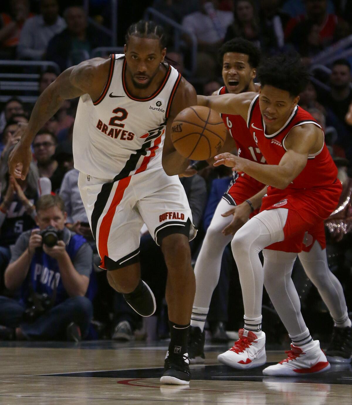 Clippers forward Kawhi Leonard tries to work the ball inside against the Portland Trail Blazers forward Mario Hezonja in the third quarter at Staples Center on Wednesday.