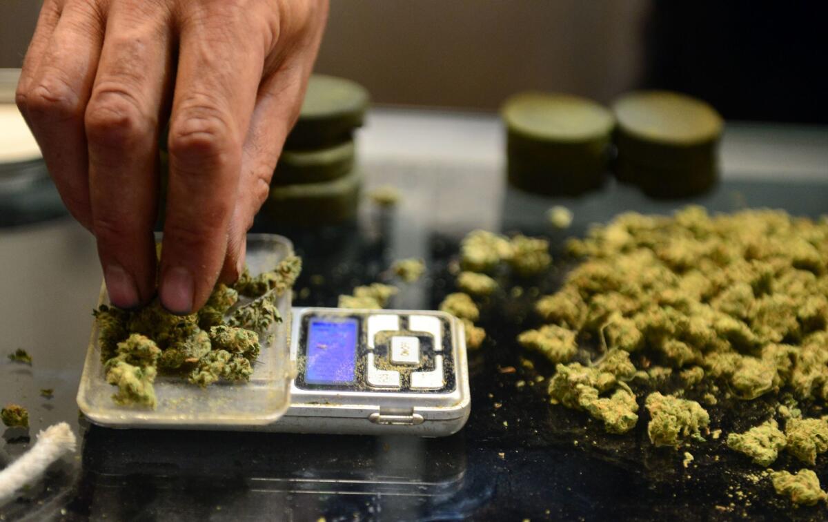 A vendor weighs buds for card-carrying medical marijuana patients in L.A.