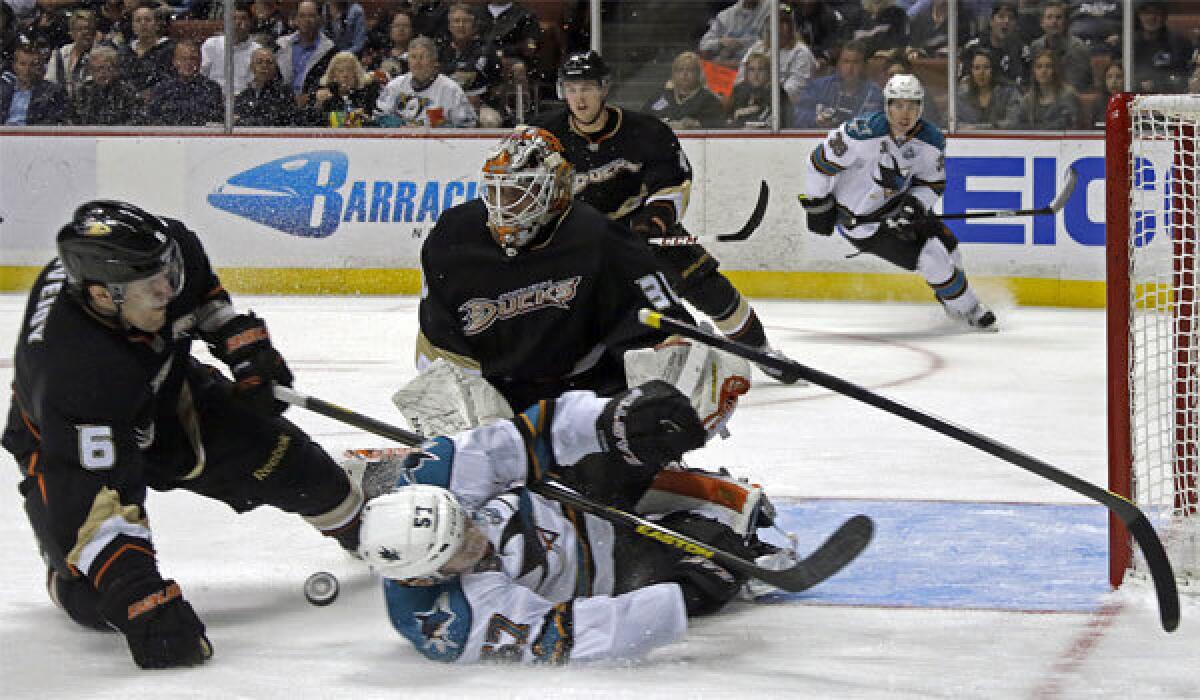 Ducks defenseman Ben Lovejoy is charged with hooking as he tangles with San Jose center Tommy Wingels on Thursday night.