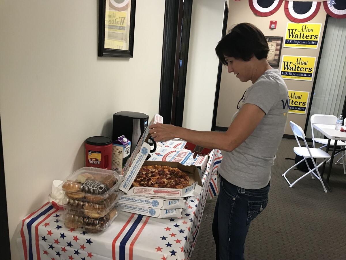 Rep. Mimi Walters (R-Laguna Beach) grabs some pizza in between phone calls to constituents at her Irvine campaign headquarters.