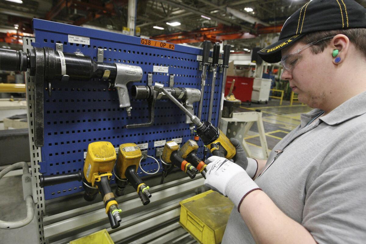 High school senior Dalton Gentry takes inventory of torque tools during his internship at the Caterpillar Inc. plant in Decatur, Ill., on Feb. 4.