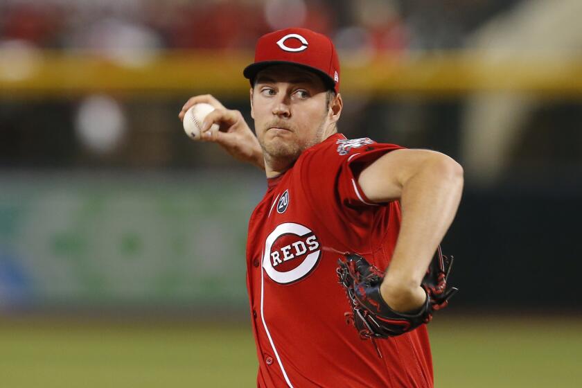 FILE - IN this Sept. 15, 2019, file photo, Cincinnati Reds pitcher Trevor Bauer throws to an Arizona Diamondbacks batter during the first inning of a baseball game in Phoenix. Lawyers for the baseball players’ union asked Major League Baseball to submit a slew of financial documents that detail the industry’s finances, a person familiar with the request told The Associated Press. "There’s so many ways to hide the money,” Bauer said in a video he posted Wednesday, May 13, 2020, on Twitter. Bauer said owners could reduce ticket prices and at the same time charge more for parking garages they control through different entities that do not benefit the club. (AP Photo/Rick Scuteri, File)