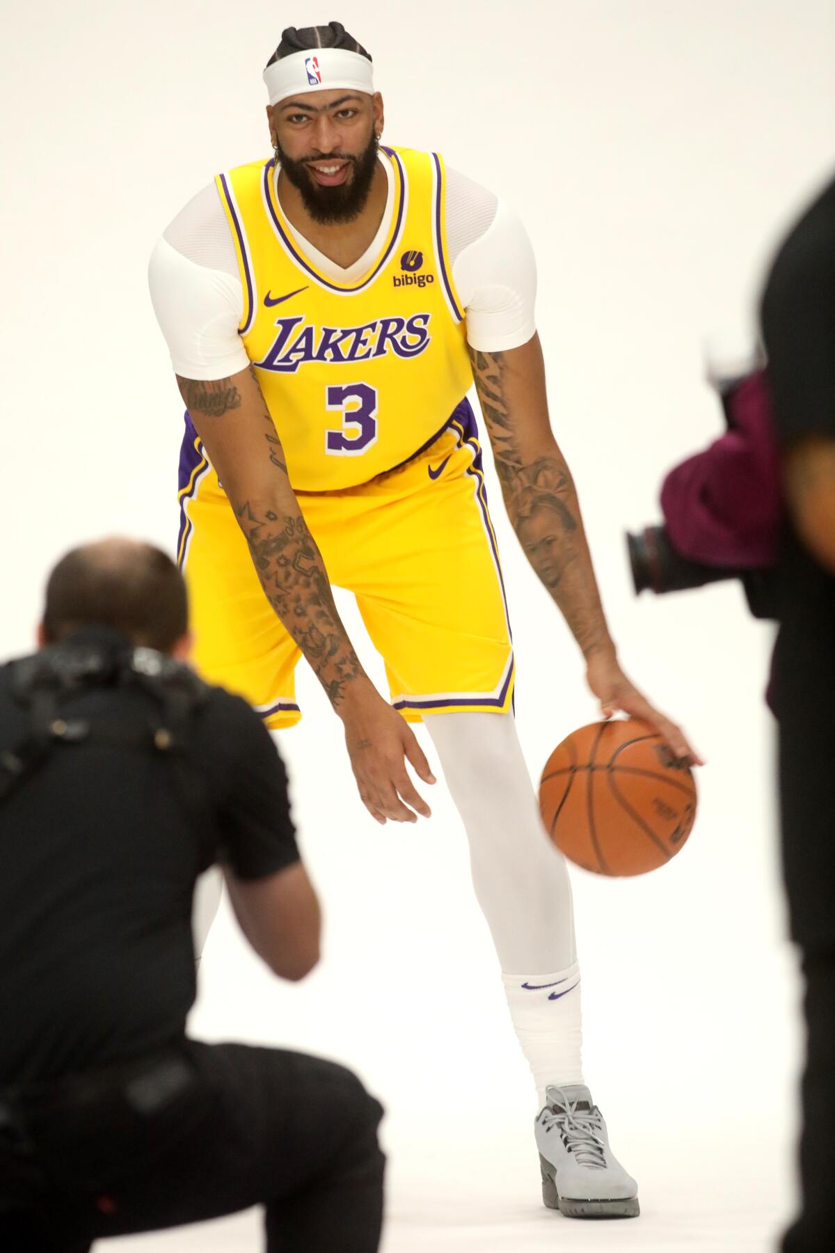 Lakers forward Anthony Davis dribbles a basketball as he poses for a photo on media day.
