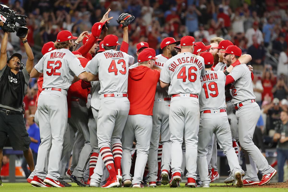 The St. Louis Cardinals celebrate their 13-1 win over the Atlanta Braves in Game 5 of the NLDS on Wednesday in Atlanta.